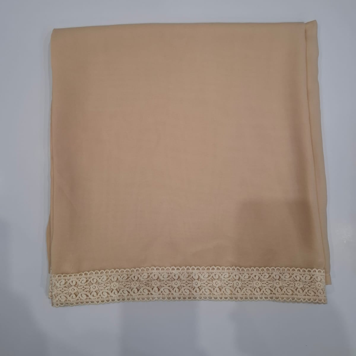 Beige fabric with lace trim on a white background