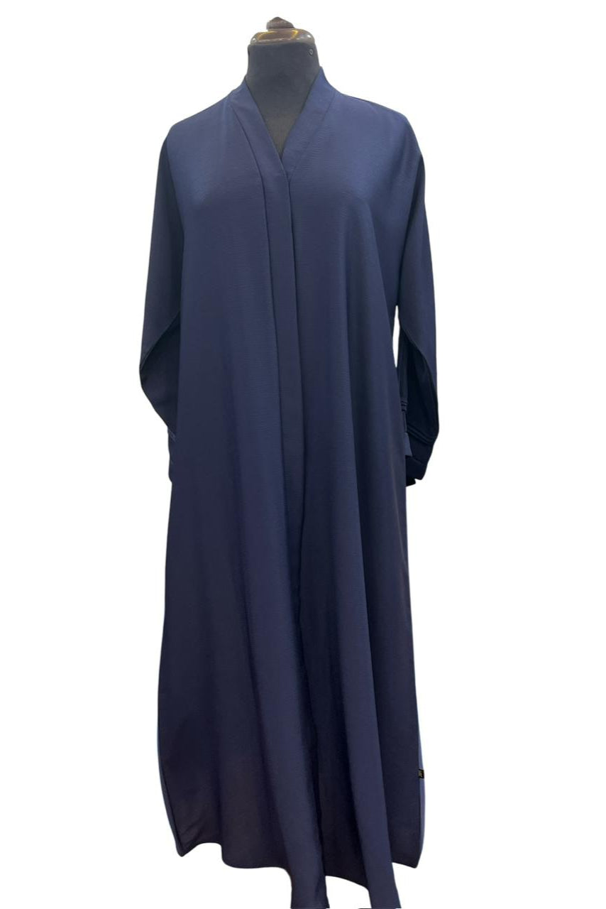 Navy blue abaya on a mannequin against a white background