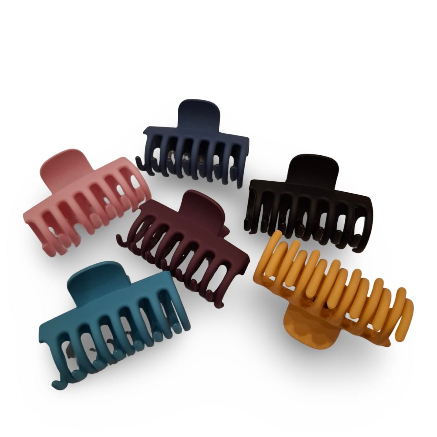 Set of six colorful hair clamps on a white background